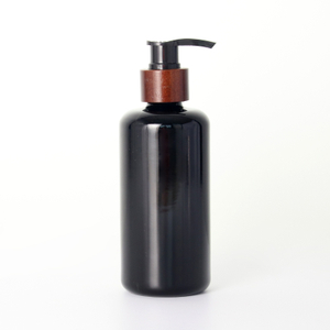 Черная стеклянная бутылка с насосом для лосьона с деревянным воротником оптом